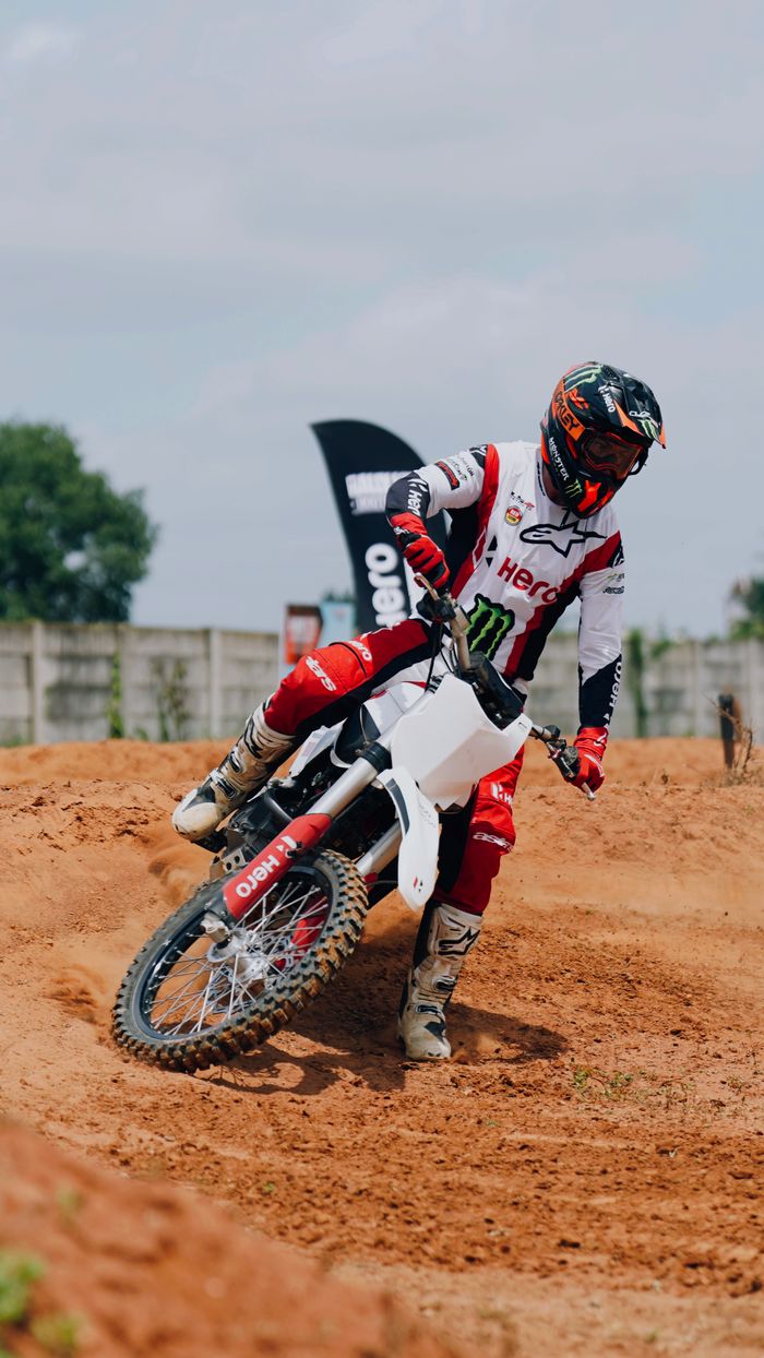Home Dynamic motocross rider in action on a dirt track, showcasing skills and speed.