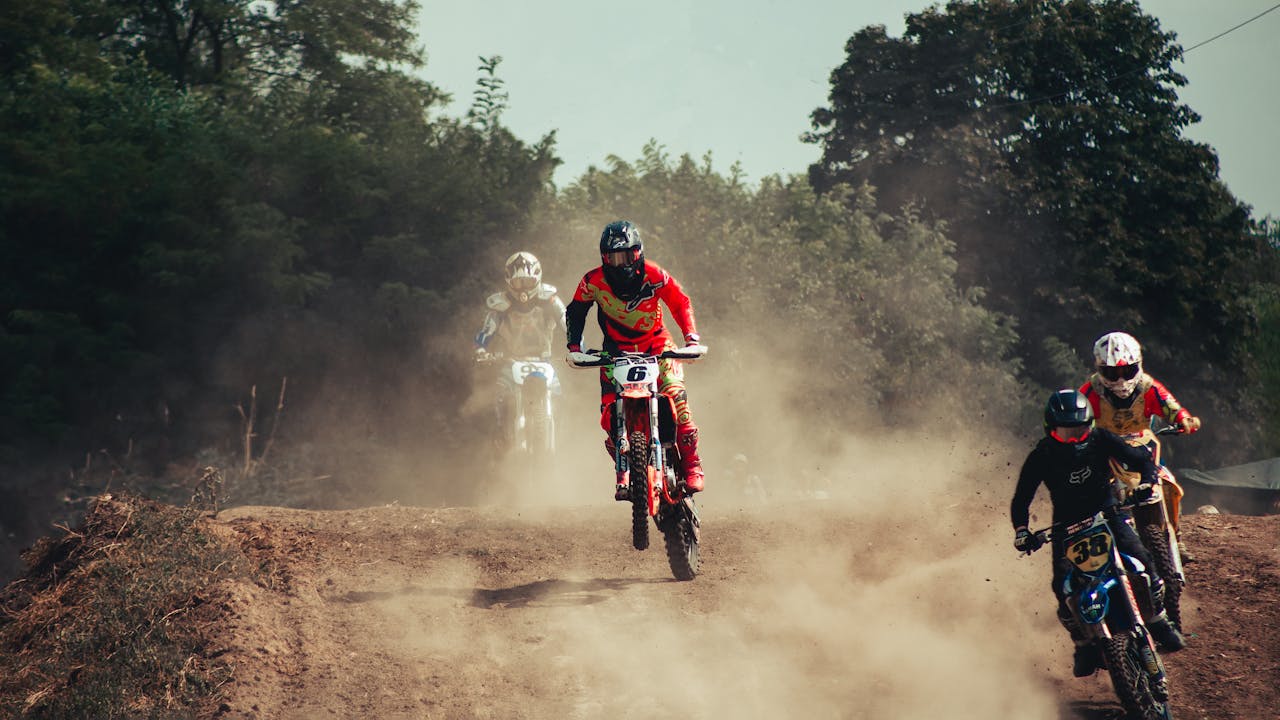 The Art of Drawing Readers In: Your attractive post title goes here Action-packed motocross race with riders speeding through a dusty track, showcasing excitement and competition.
